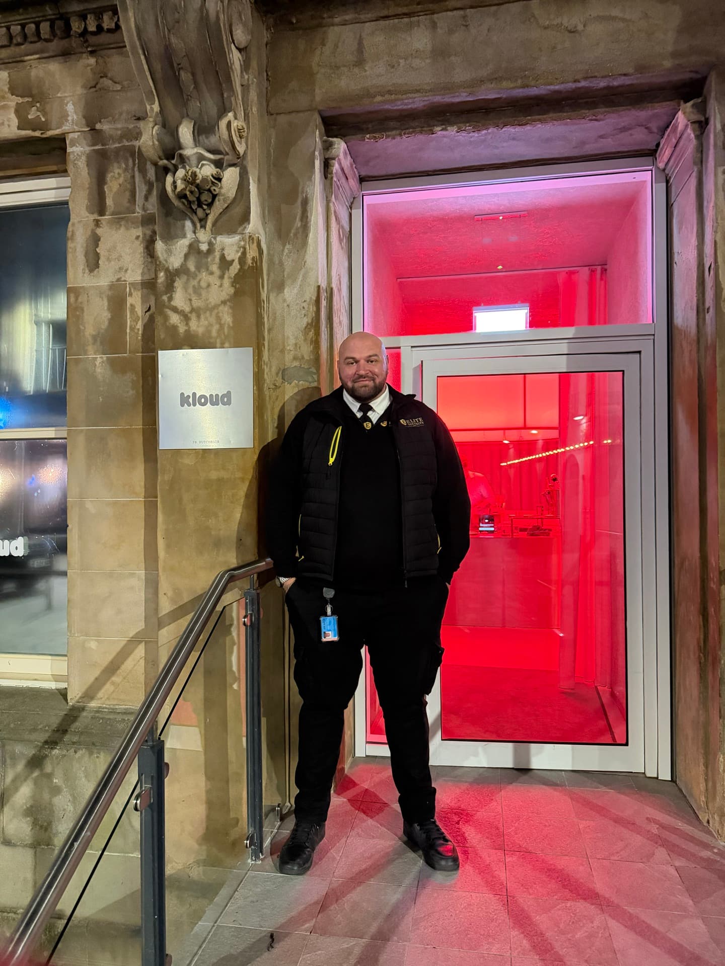 Elite Security door supervisor at a city-centre venue entrance at night